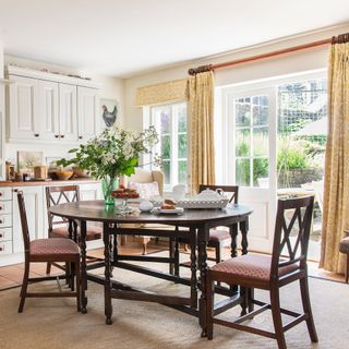 traditional style kitchen diner with french doors to garden