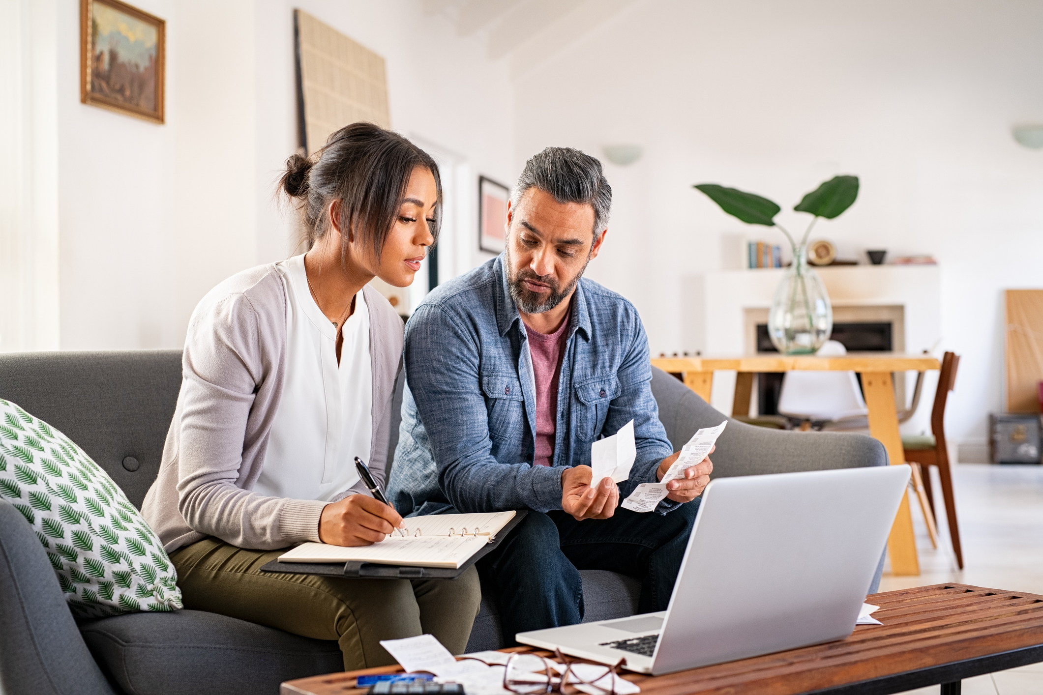 Couple sitting on sofa considering Sipp investments