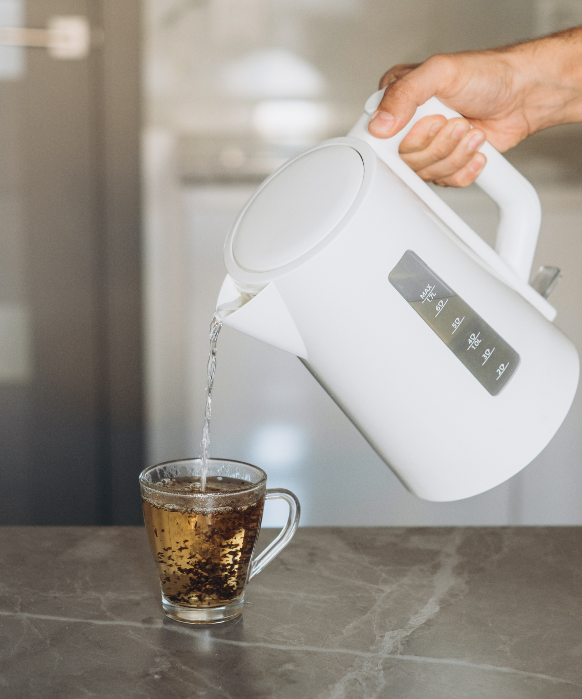 A cheap plastic kettle pouring tea