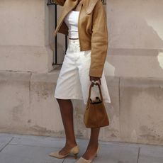 @daniellejinadu wears white denim Bermuda shorts with pointed-toe heels