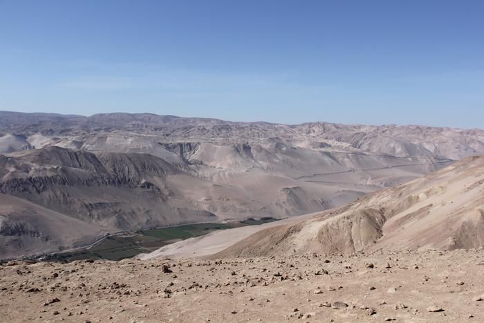 A series of brown hills in the desert.