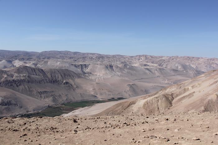 A series of brown hills in the desert.
