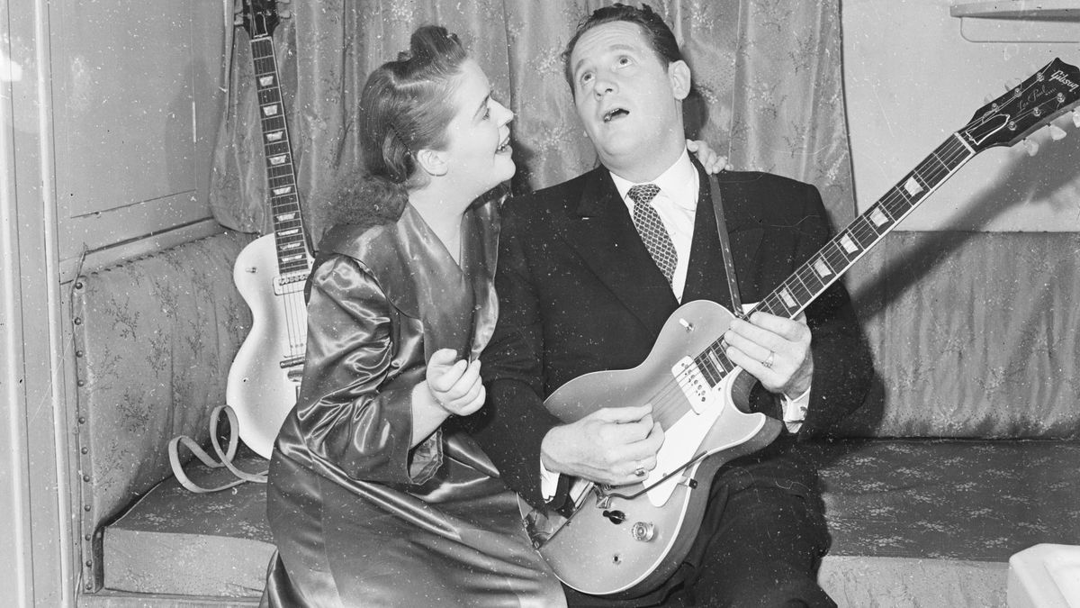 16th September 1952: guitarist Les Paul serenades his wife and singing partner Mary Ford