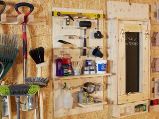 storage wall units in a shed for storing garden tools