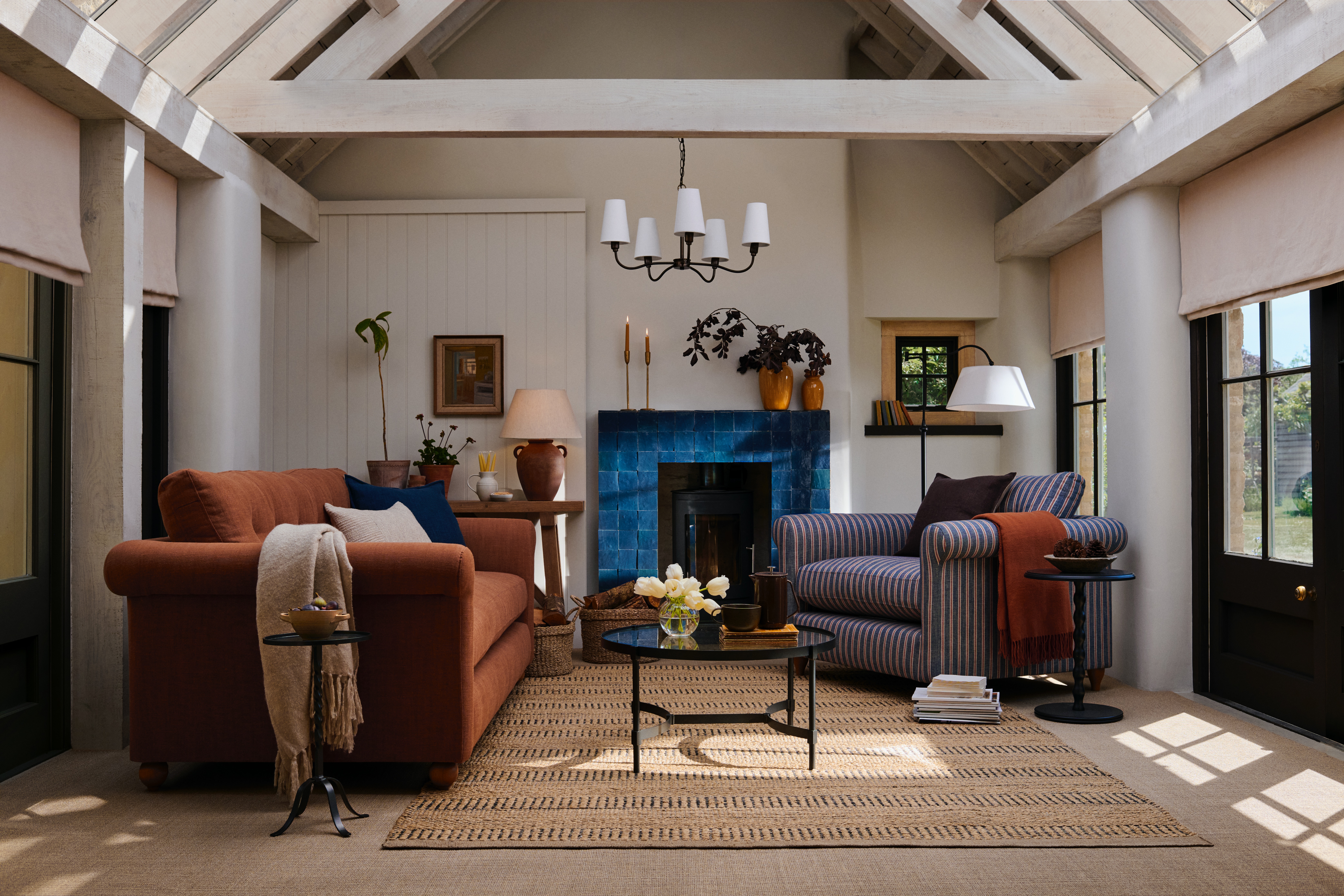a transitional living room with a rust and blue striped sofa