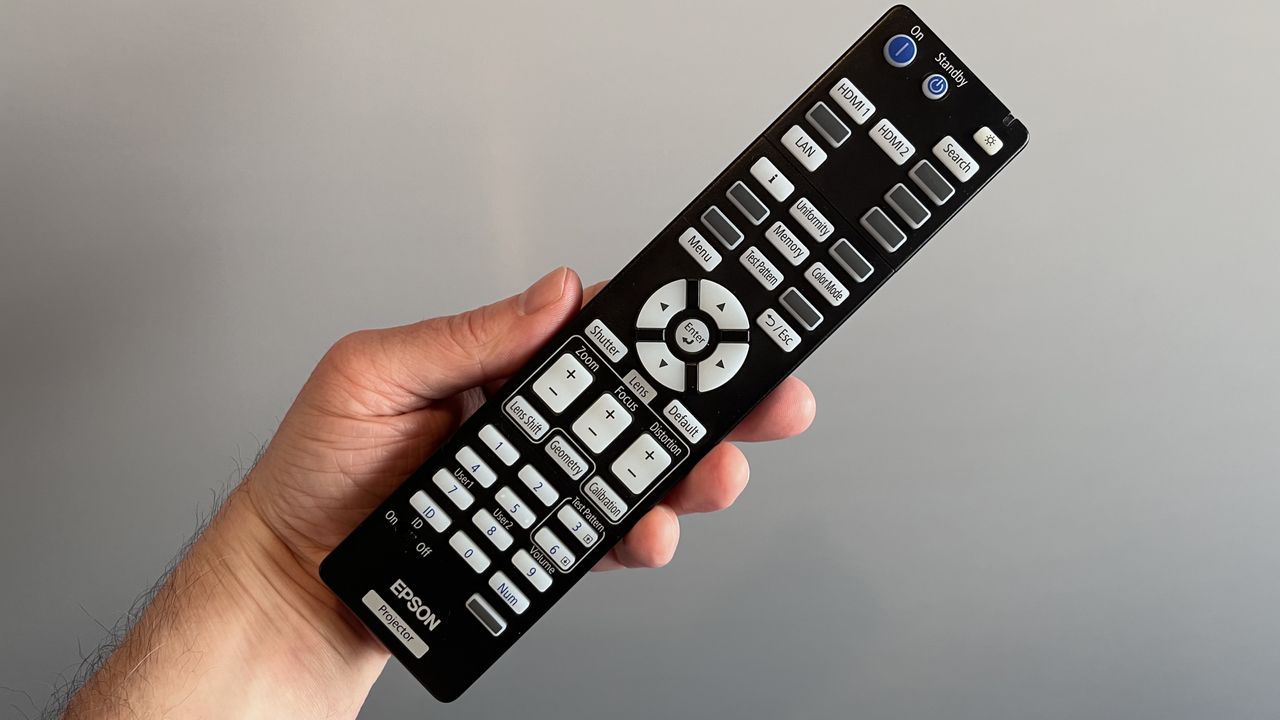 Epson QL7000 remote control held in hand