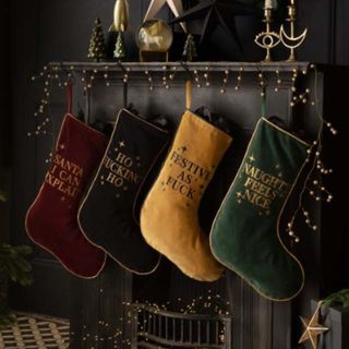 Best christmas decorations stockings by fireplace on dark background with glitter 