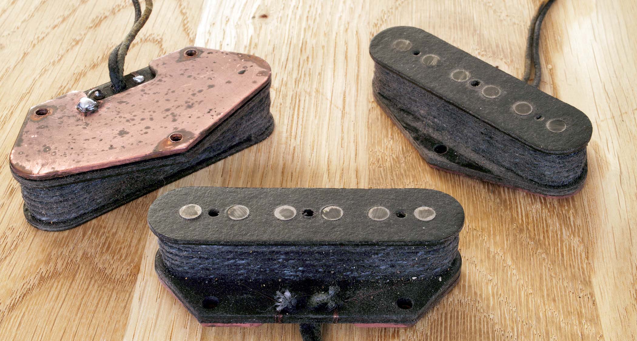 The wax turned the string and leadout wires black, and the finished pickups are treated to some light ageing