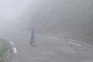 Alfie Earl riding through the fog to reach the summit of the Col du Tourmalet