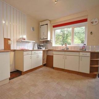 Before shot of dated white kitchen