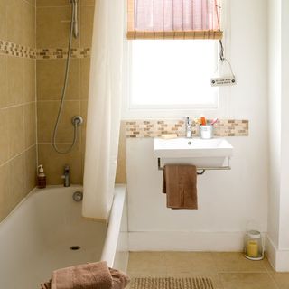 bathroom with bathtub and basin with towel