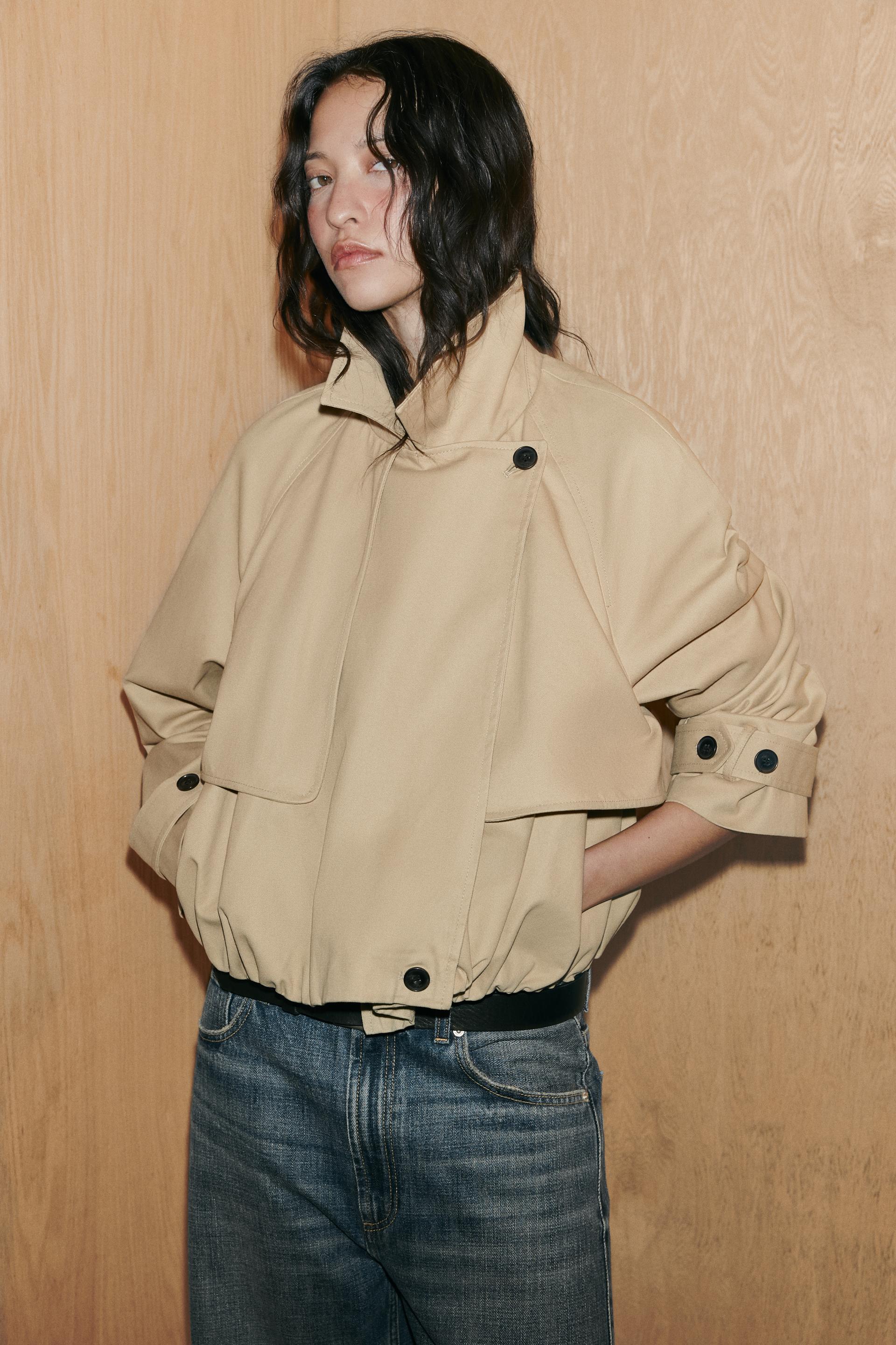 Model wears cropped trench coat