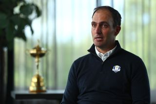 Edoardo Molinari sits in front of the Ryder Cup trophy