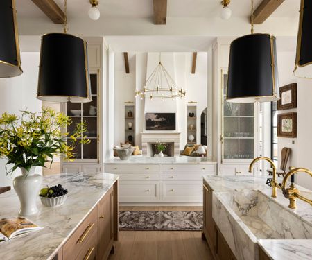 A double island kitchen with a hatch into the living space