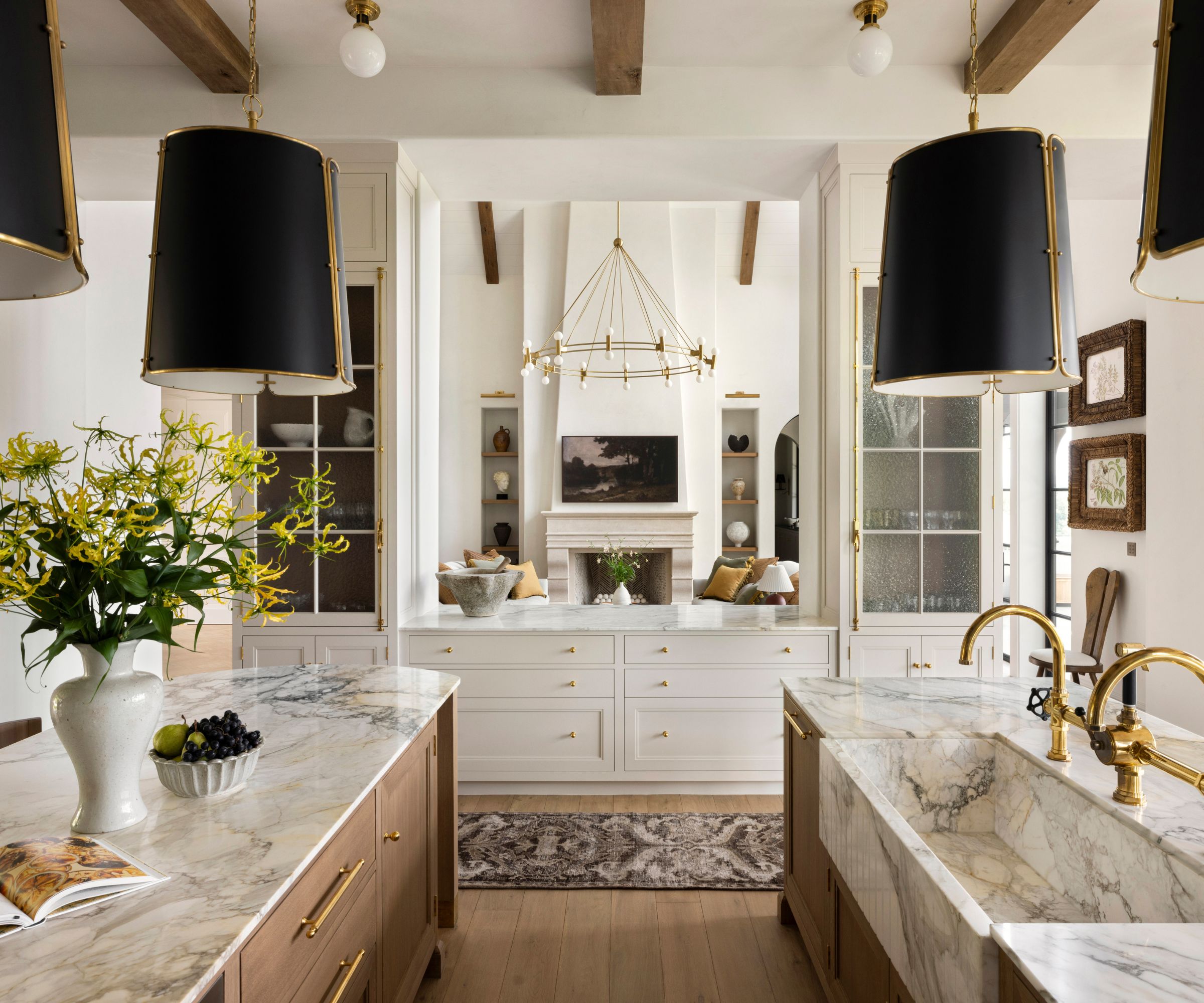 A double island kitchen with a hatch into the living space