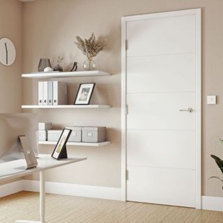 White horizontal panelled fire door in home office with desk, PC, wall shelves, wood floor and beige walls