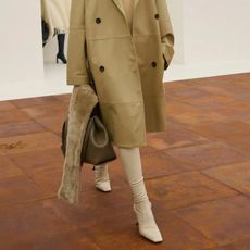 A model wears sock boots on Toteme's autumn/winter 2025 runway