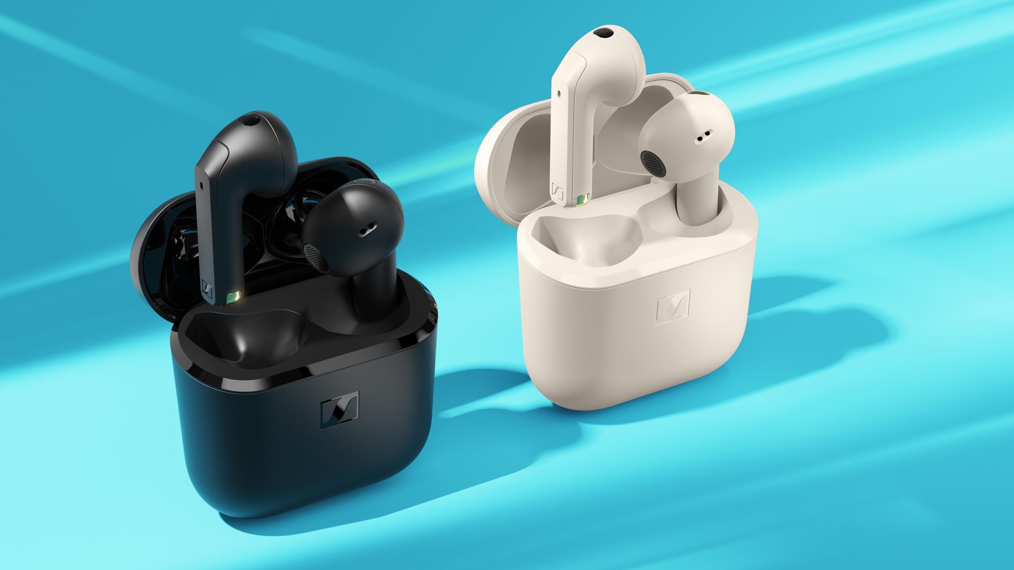 Product photography of Sennheiser Open earbuds in black and beige on a light blue background. The headphones are in their cases with one bud floating slightly above each case.