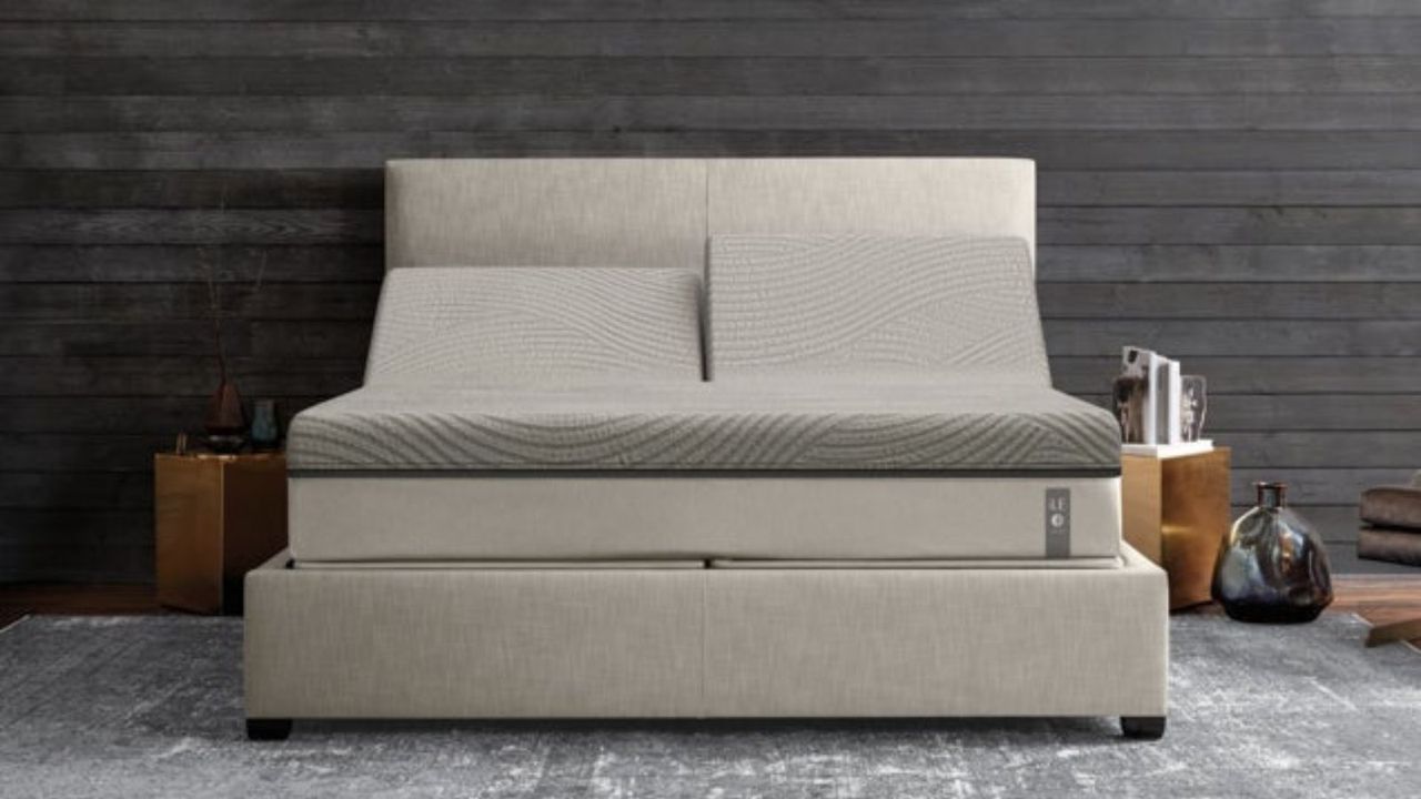 An orthopedic mattress, from The Sleep Number Innovation Series, against a gray wall.