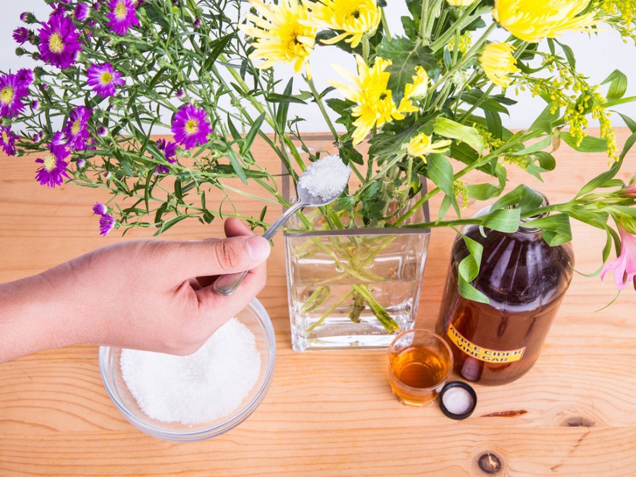 Apple Cider Vinegar And Sugar Near A Vase Of Flowers