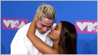 Pete Davidson and Ariana Grande cuddling at the the 2018 MTV Video Music Awards at Radio City Music Hall on August 20, 2018 in New York City