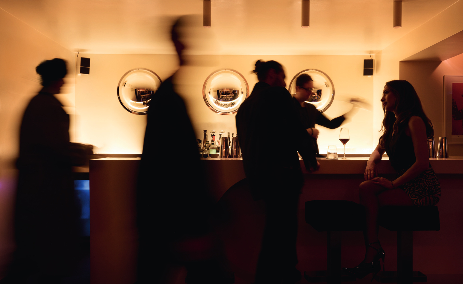view of an underground bar in london defined by low lighting and velvet textures