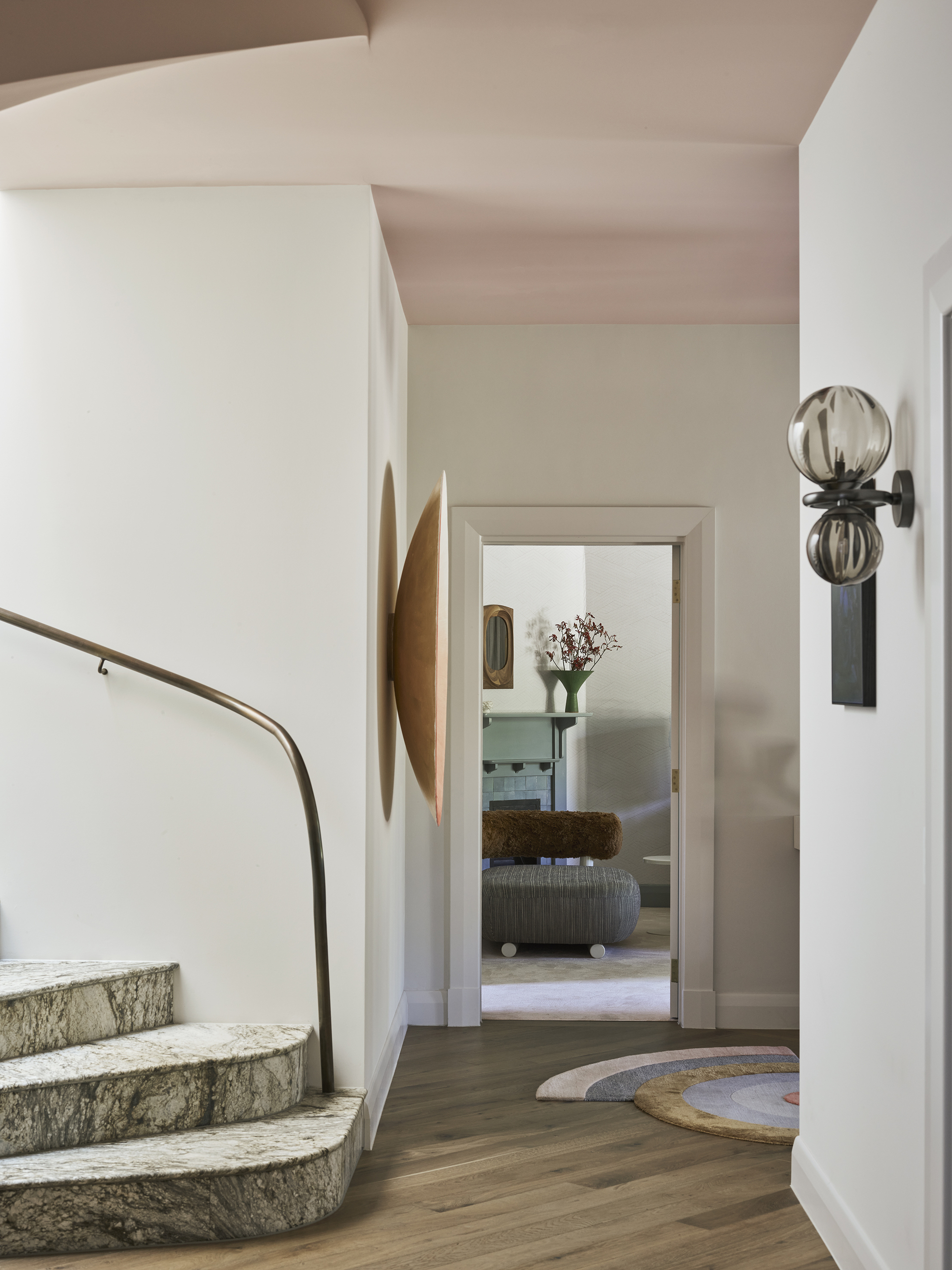 entryway with stone staircase, pink ceiling, timber floorboards, sculptural lights on wall