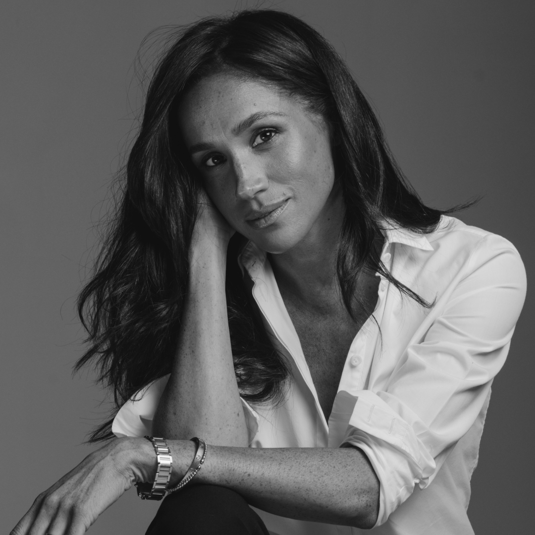 A black and white photo of Meghan Markle wearing a white shirt 