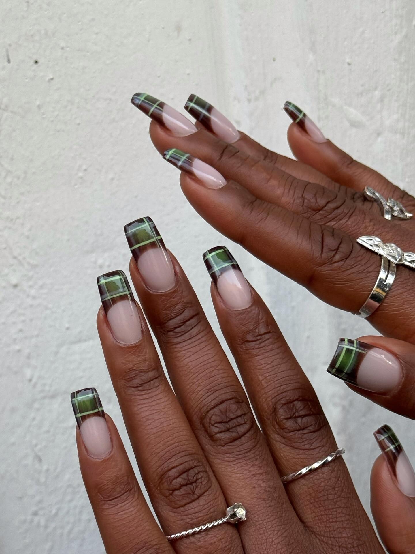 Deep brown and mossy green French nails.