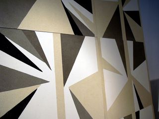 Close up view of 'Refraction Tiles' by Blatt Chaya and Lindsey Adelman - black, grey, white and beige geometric tiles