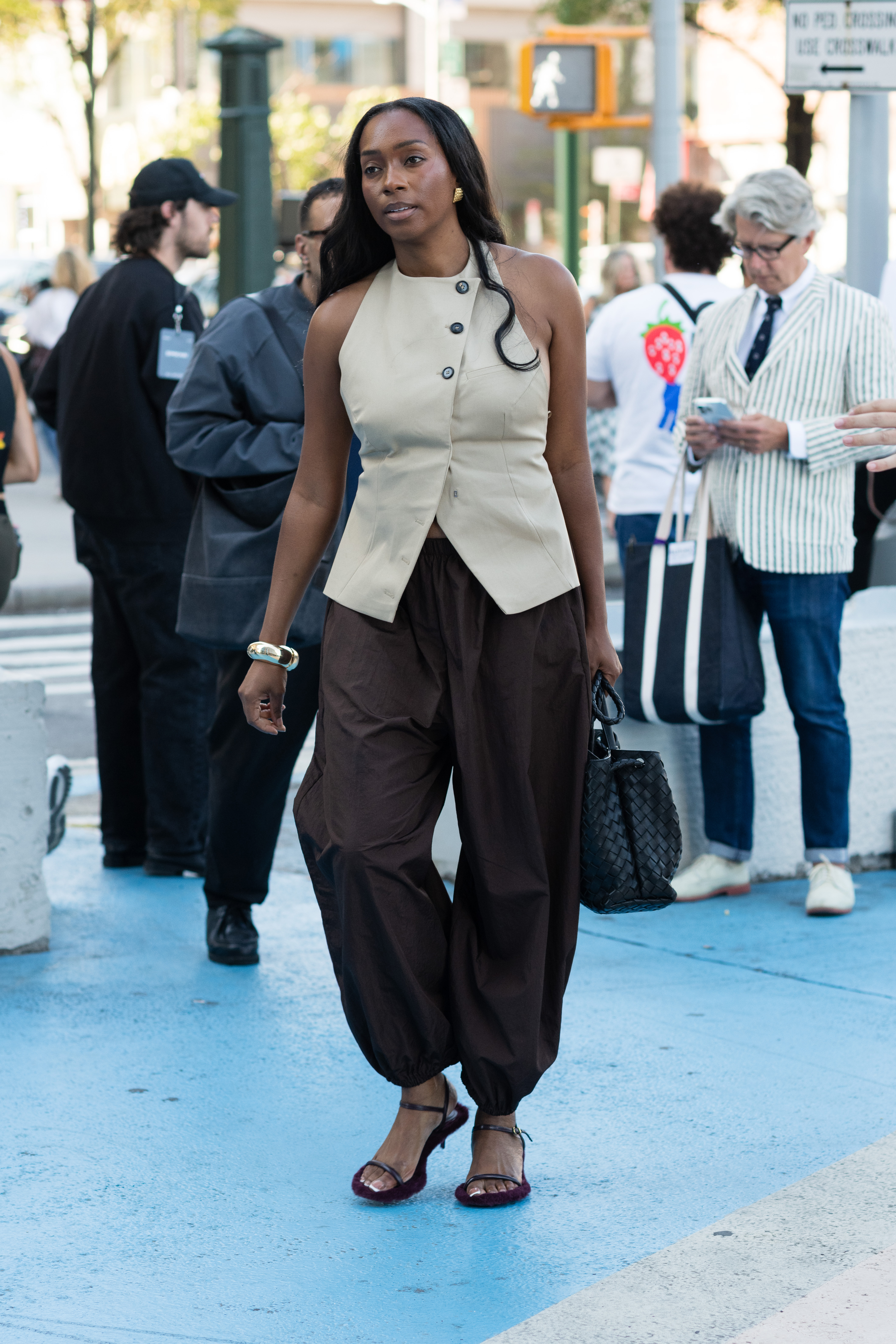 Woman in brown balloon pants and a vest