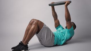 Man doing weight plate exercise