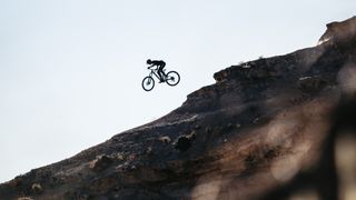 The Mondraker Crusher e-MTB being ridden of a massive jump
