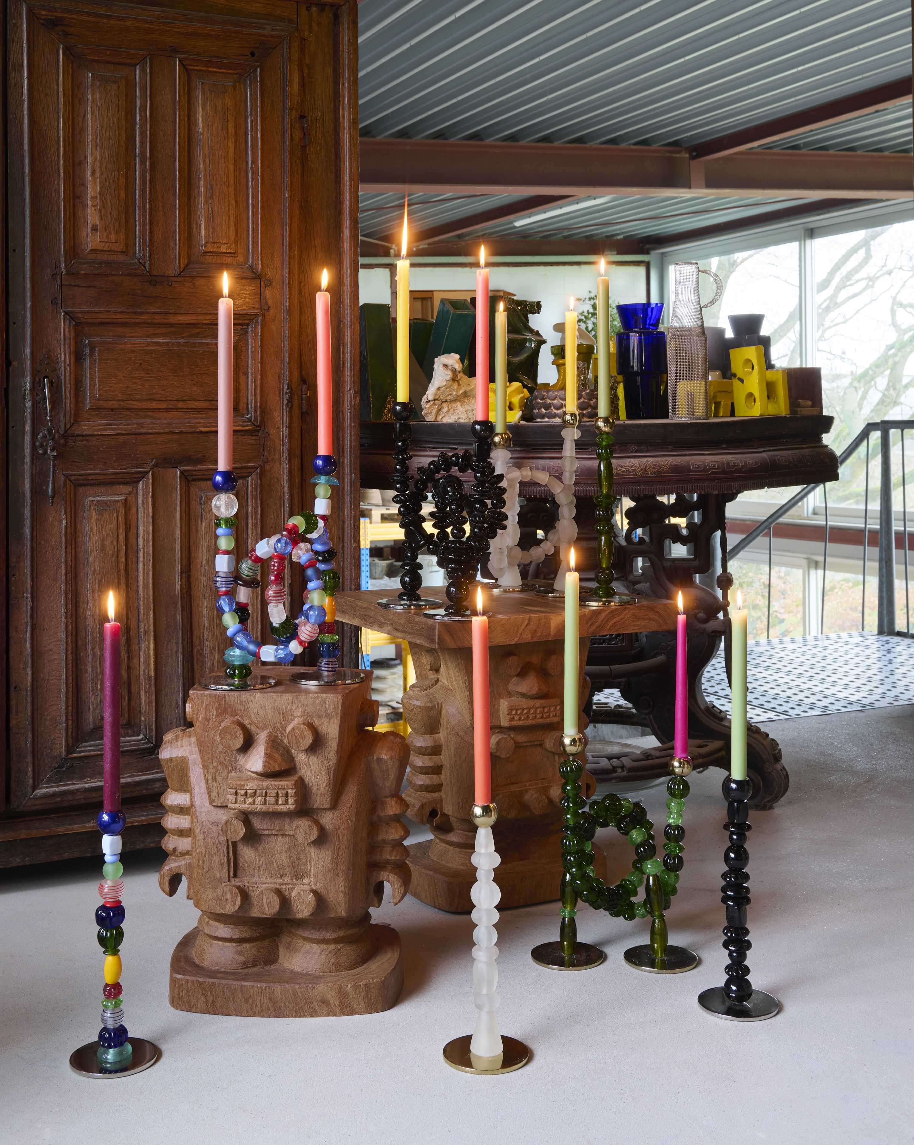 a number of beaded candlesticks with candles