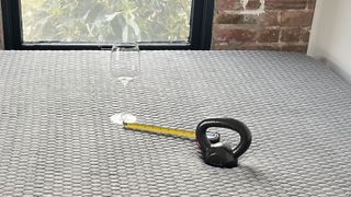 A wine glass, weight and tape measure on the Layla Hybrid Mattress