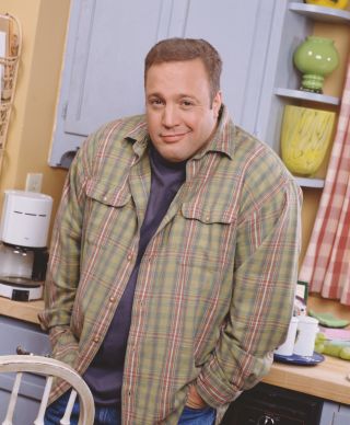 Promotional portrait of American actor and comedian Kevin James in costume as the character Doug Heffernan as he poses with his hands in his pockets on the set of the television sitcom 'The King of Queens,' late 1990s.