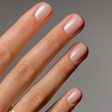 A close-up of hands with organza nails; a sheer pearl finish