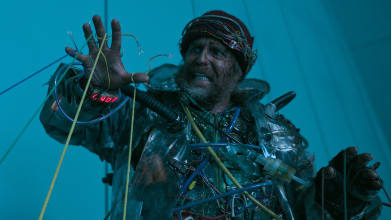 Sam Rockwell looking scared at cords in Good Luck, Have Fun, Don't Die.