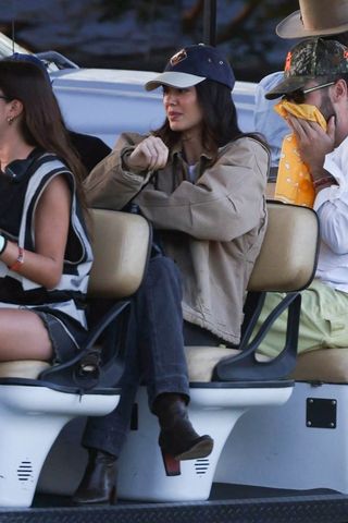 kendall jenner at Stagecoach wearing a carhartt jacket, jeans, and boots