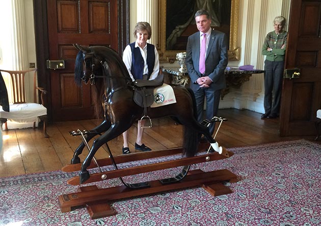 Lance Bradley presents the rocking horse to the Duchess of Beaufort
