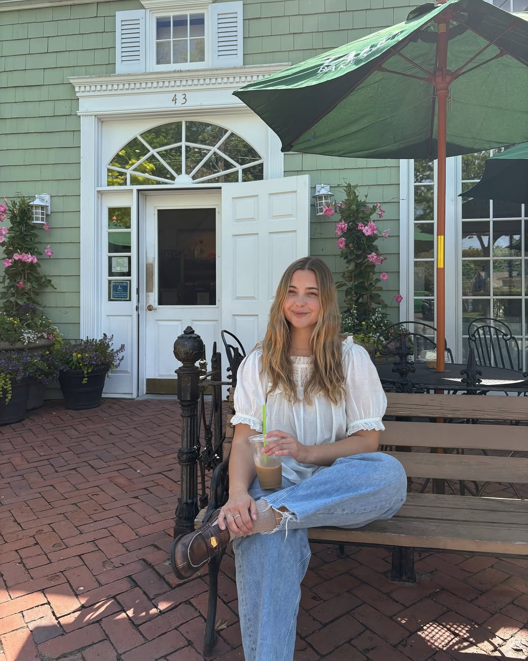 @oliviamarcus wearing an embroidered blouse and jeans