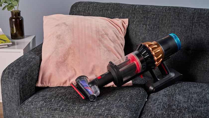 Dyson V16 Piston Animal vacuum with updated Hair screw tool, lifting pet hair from a velvet cushion