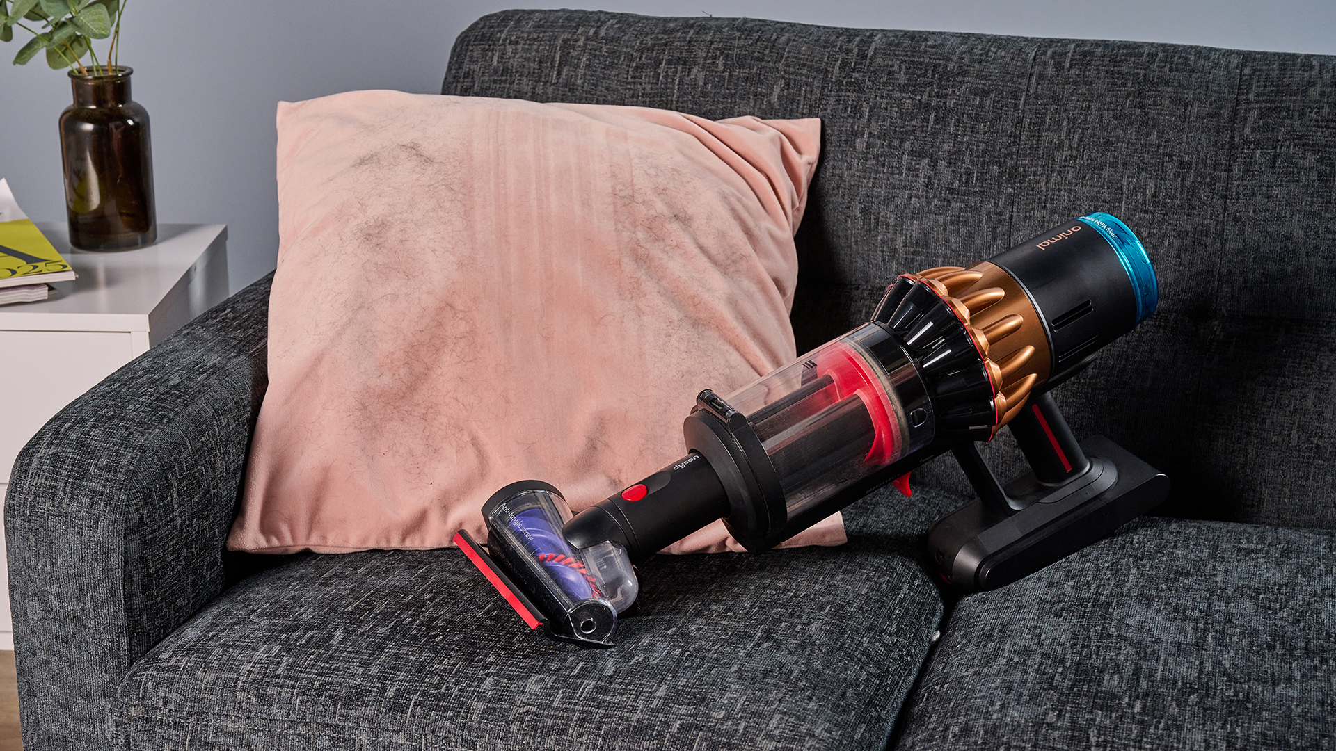 Dyson V16 Piston Animal vacuum with updated Hair screw tool, lifting pet hair from a velvet cushion