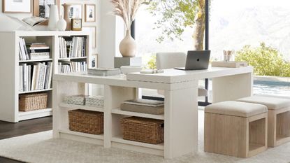 Office with white desk, storage baskets, and neutral stools