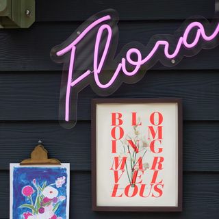 photo frame with floral painting and neon pink light
