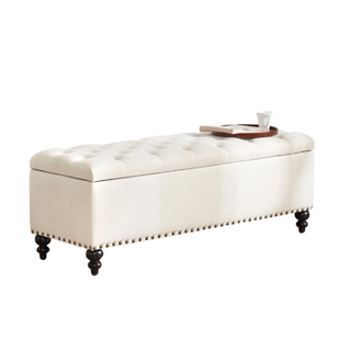 A white storage ottoman with a button-tufted