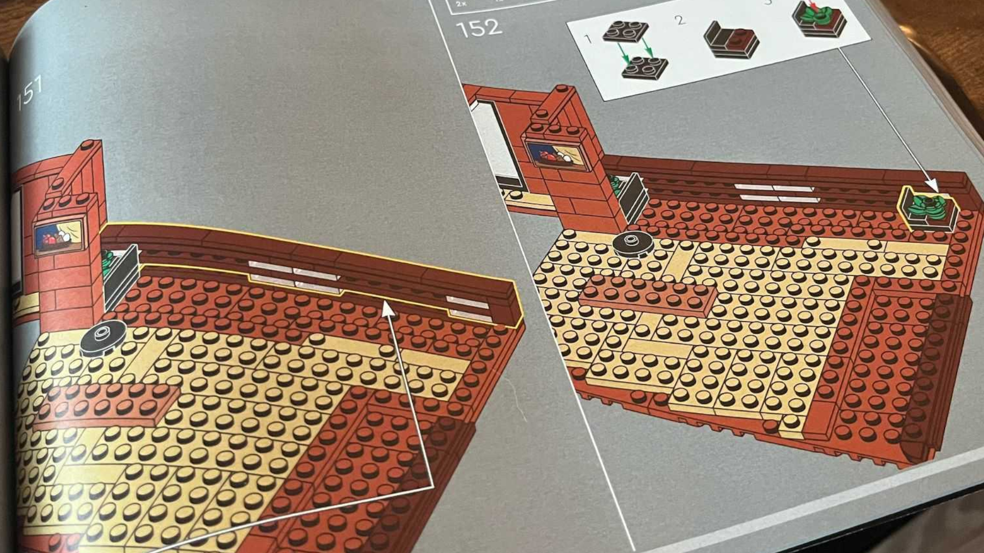 The Lego Twilight instruction booklet on a wooden surface