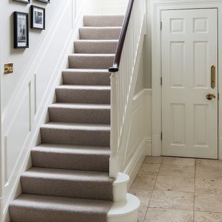 staircase with carpet white door and frame