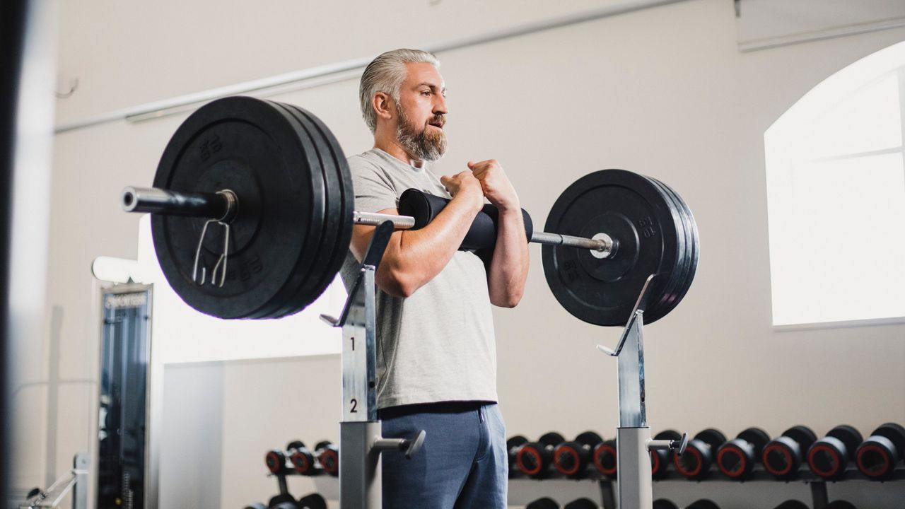 Zercher squat being performed by man in the gym