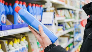 A shopper looking at a cleaning product